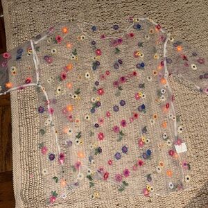 Women’s sheer white top with colorful flower embroidery